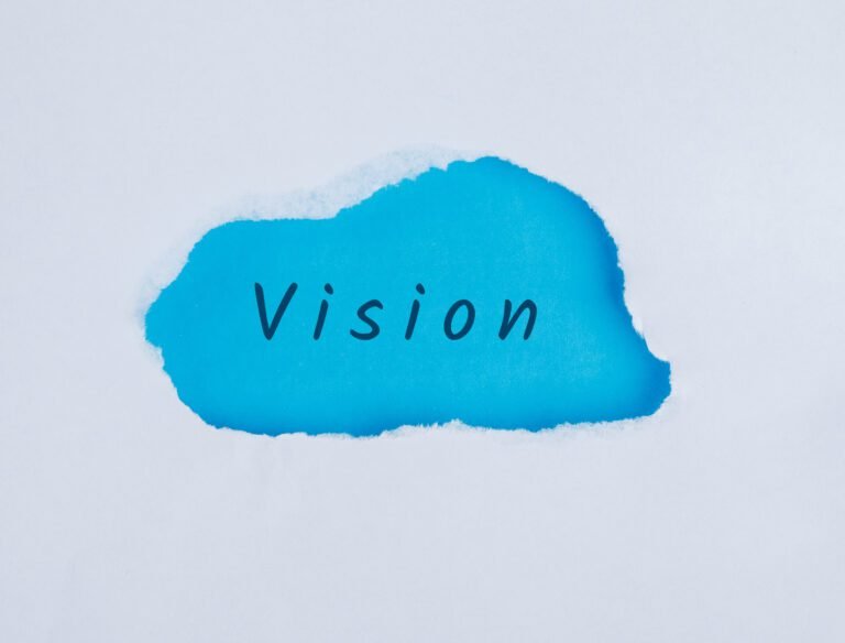 Marketing concept with vision word on blue and white background flat lay.